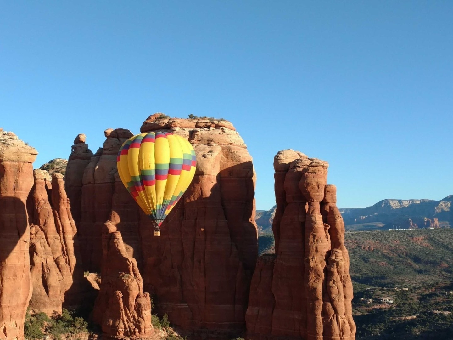 a canyon with a kite in front of a mountain